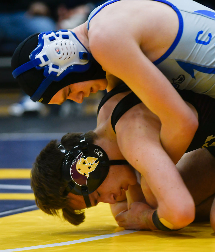 Capital City's Keaton Schrage pushes Desmet's Andy Cross to the mat